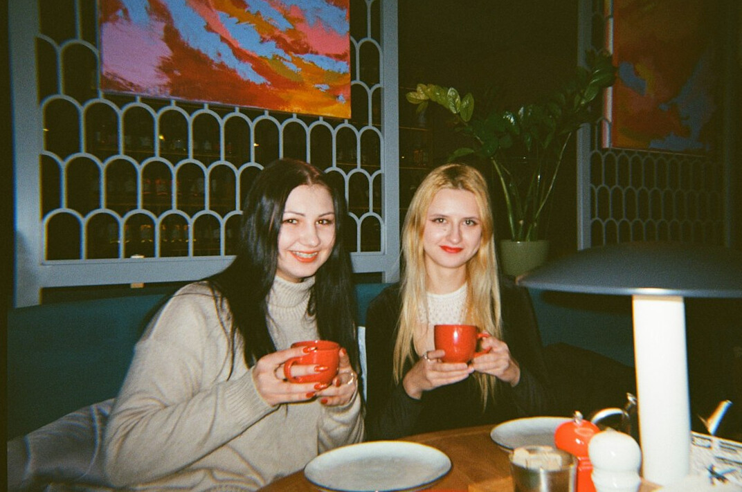 Two friends talking and smiling at a table